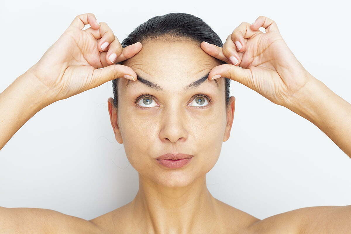 Woman checking for forehead wrinkles