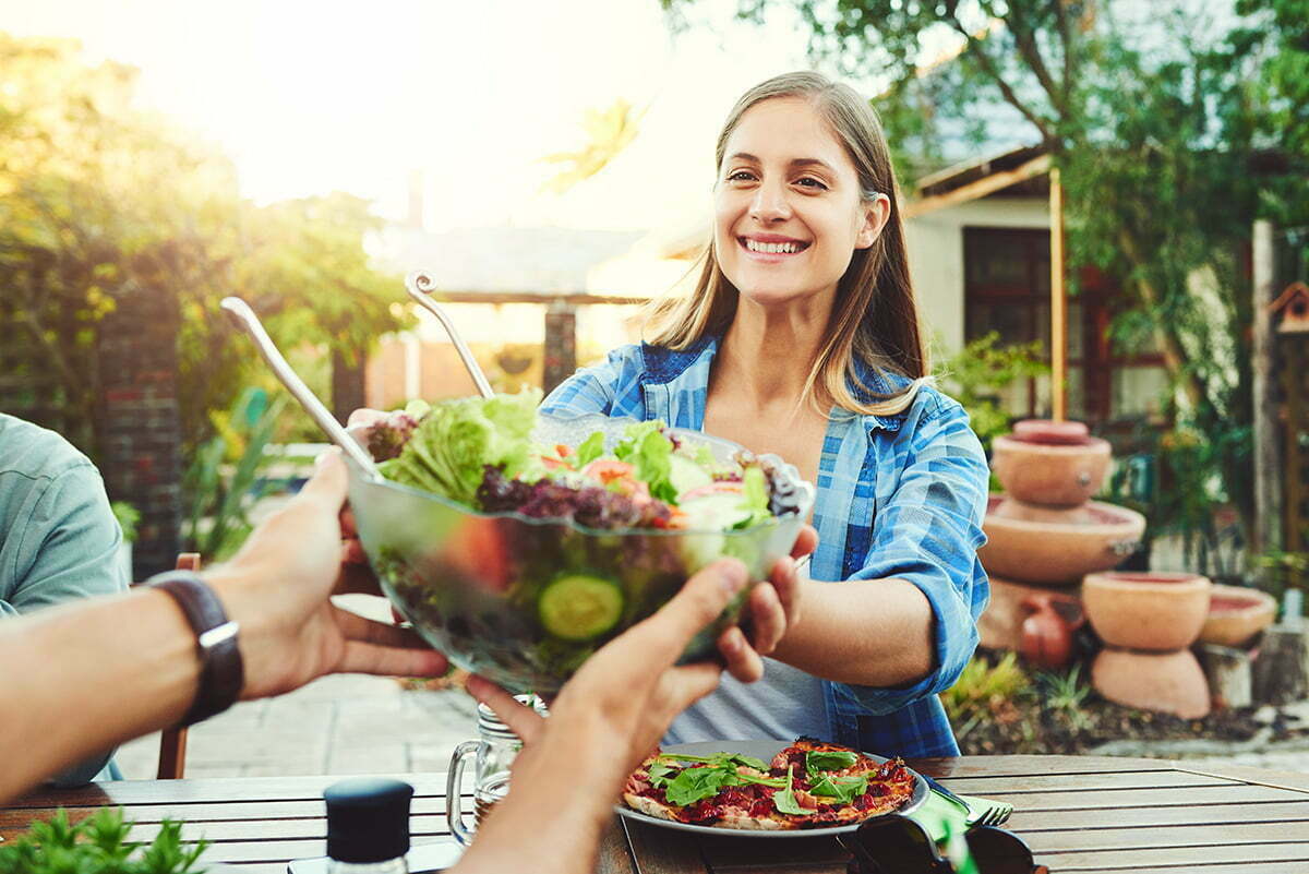 Woman holding beautiful, healthy salad greens