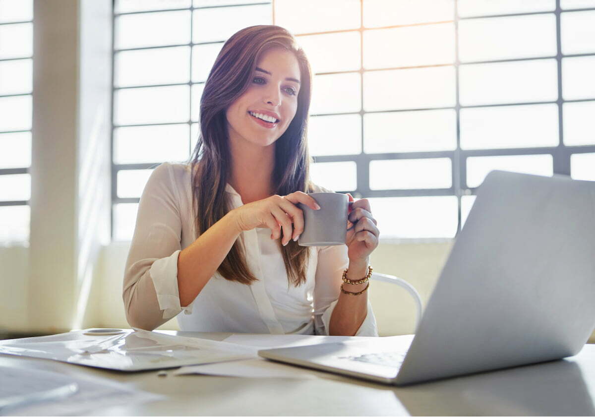 Woman Enjoys Small Cup of Coffee to Stay Productive While Microdosing Caffeine Throughout the Day