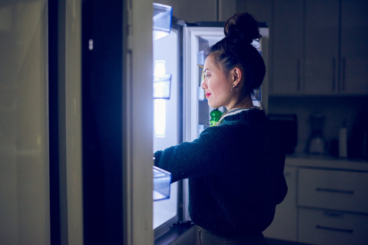 Woman Searching Fridge for a Late-Night Snack