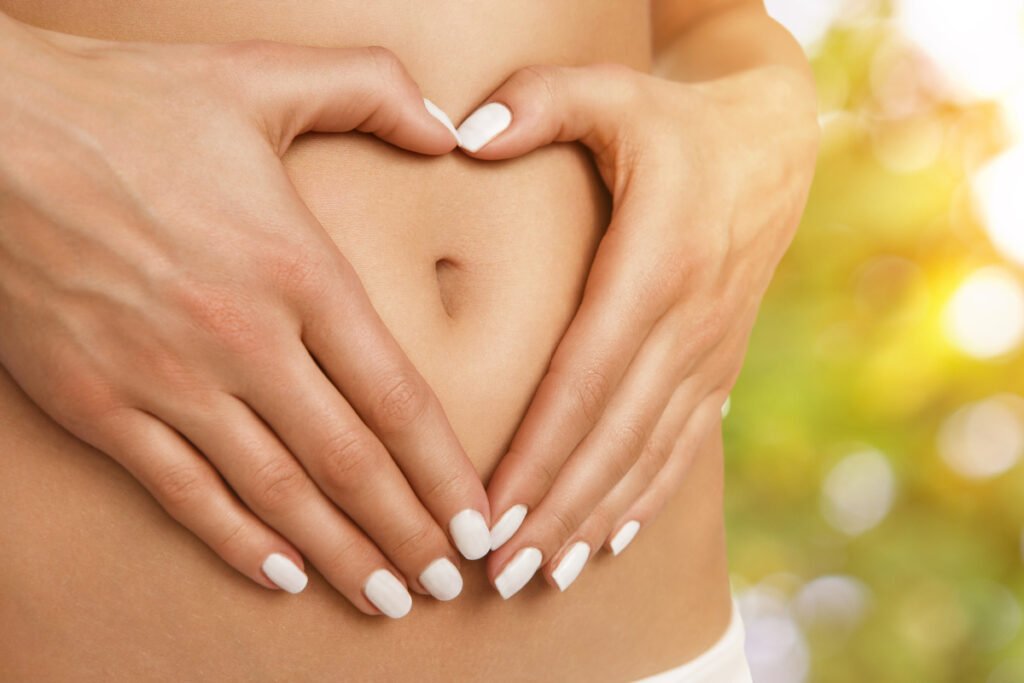 Woman with hands over healthy stomach